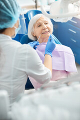 Senior woman under teeth examination from dentist