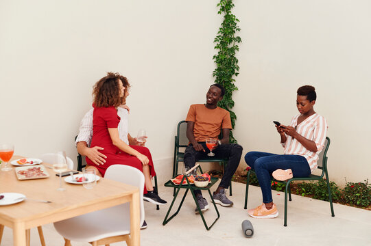 Smiling friends having lunch on a patio