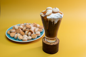 coffee drink with delicate jam and flowing foam on a yellow background