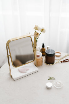 Mirror and cosmetic products on table