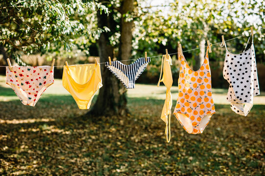 swimsuits and bikinis lying on clothesline in the sun
