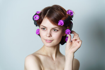 happy woman with curly hair purple curlers hairstyle bare shoulders