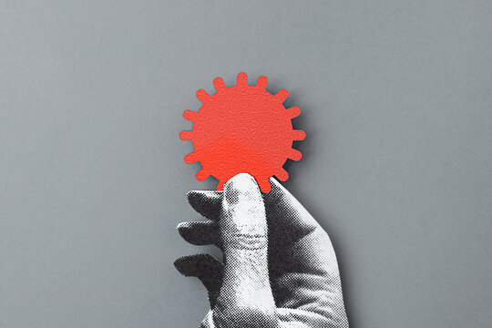 Hand holding a corona virus