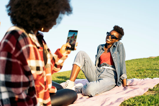 Afro Girl Photographing her Friend