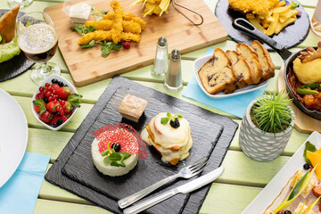 tasty fresh brunch, on restaurant table, outside