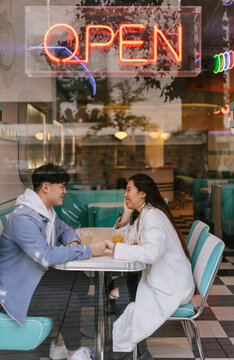 Chinese young couple dating in restaurant