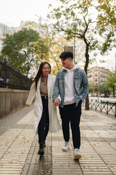 Chinese couple walking through the city on an autumn day