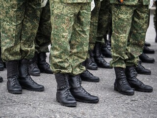 Detail of soldiers standing at attention during military ceremony.