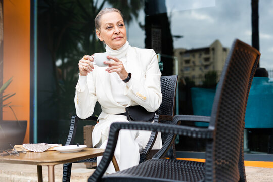 senior business woman drinking a coffee at coffee shop