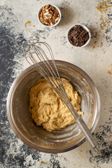 Making some cookies: cookie dough in the making, with a wisk and a spoon
