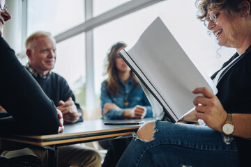 Businesswoman discussing over a contract during meeting