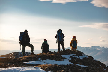 Four hikers are relaxing on mountain top