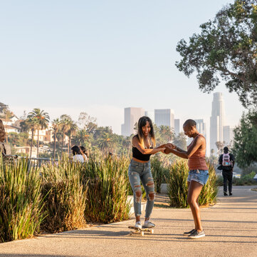 Friends Learn To Skate Together At the Park