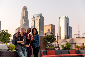 Friends Have A Group Hug and Cheers On A Rooftop