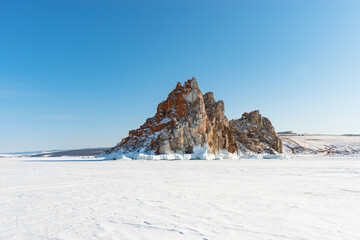 Fototapeta na wymiar Sacred Shamanka Mountain on Olkhon Island in winter. View from the frozen Lake Baikal.