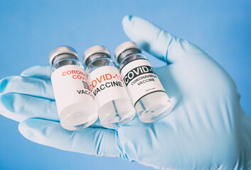 The nurse holding three types of covid 19 vaccines in hand