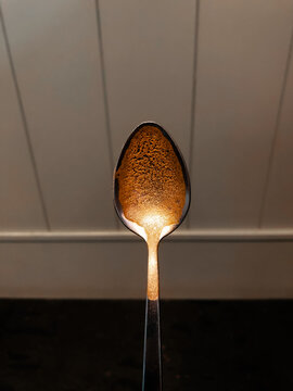Coffee spoon with foam right in the middle of the wall and the floor.