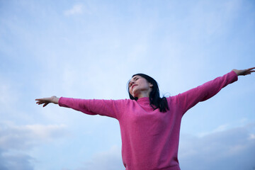 Fototapeta na wymiar happy young woman enjoying freedom with open hands