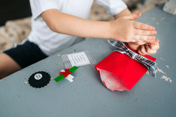 A little boy makes a handmade gift.