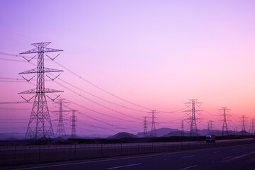 Fototapeta na wymiar high-voltage electricity poles Tower - power station - distribute Electric energy , sunset