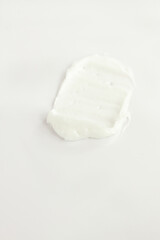 White face body hand legs cream smashed on white, cosmetic texture, skin care, facial treatment cosmetics 