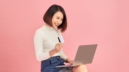 Woman using laptop computer for online shopping