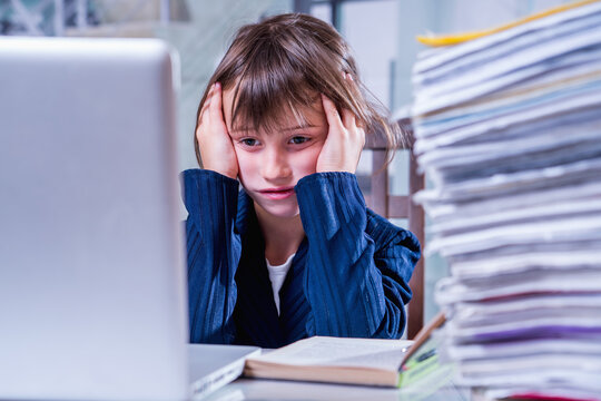 Toxic Work Concept. Humorous Photo Of Tired And Exhausted  Business Child Girl Working Alone In Office With A Lot Of Documents.