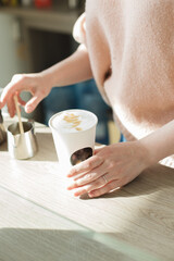 barista girl making hot coffee with milk