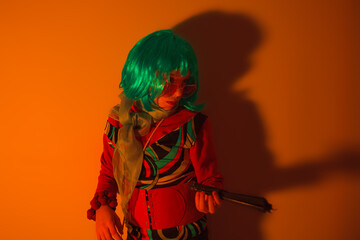 Little girl posing with a fan for a photo shoot
