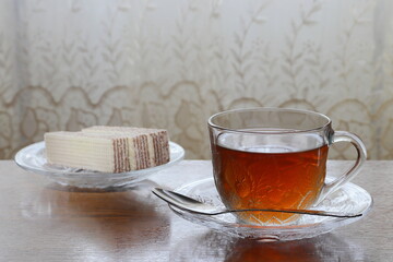 Tea in a transparent cup on a saucer.