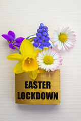 Flowers and padlock, with "Easter lockdown" written in black. Easter lockdown.