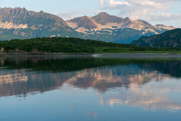 View of the coast and mountains of Geographic Harbor, Katmai, Alaska just after sunrise.