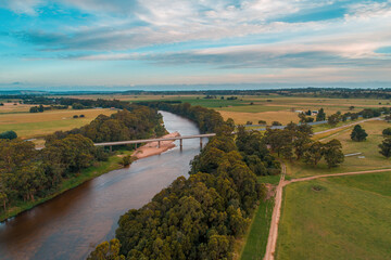 Fototapeta na wymiar Highway bridge across a river in rural area - aerial view