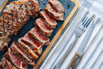 juicy fresh fried steaks for dinner. two fried striploin steak in a medium roasting rare