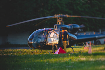 Civil black helicopter getting ready to fly, commercial charter private copter at helipad airfield...