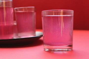 red drink of milky preparation of raspberry blueberries or kulbnik mors juice compote on a red background with a place for text and copyspace © Кристина Шоба