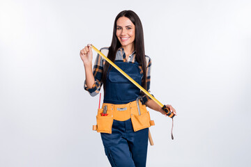 Photo of happy smiling cheerful woman constructor handyman hold tape meter isolated on white color...