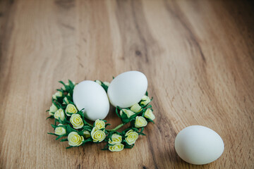 Easter white eggs wooden background flowers