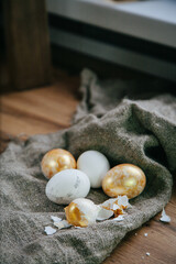 Fototapeta na wymiar golden eggs Easter wooden background