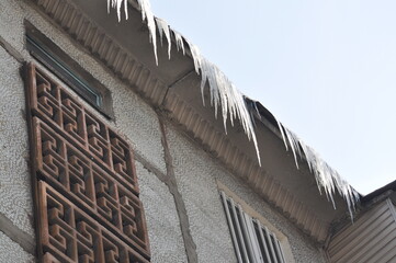 Icicles hang from the roof of the balcony