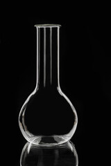 Laboratory glass chemical flask on a black background. Laboratory equipment.