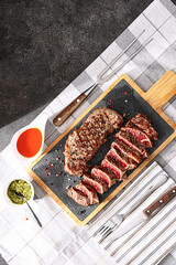 juicy fresh fried steaks for dinner. two fried striploin steak in a medium roasting rare