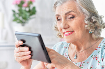 Portrait of  Old woman  with tablet pc