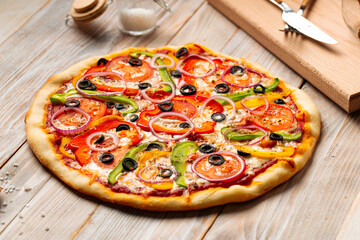 Side view on vegetable pizza with pepper and tomatoes 