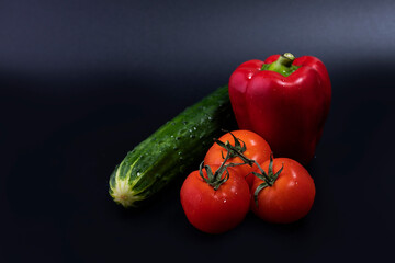 Cucumber, tomatoes and red pepper for making a healthy vegetable salad.