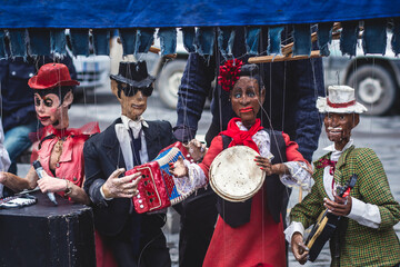 View of street puppet show theatre, with puppeteer puppet master pulling the strings over...