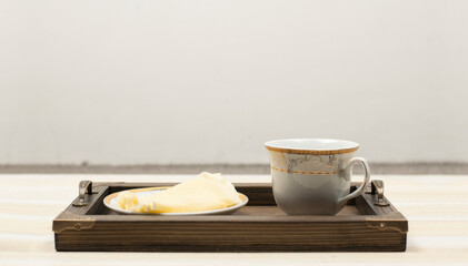 Wooden tray. Pancakes on a plate and a cup of coffee. Breakfast