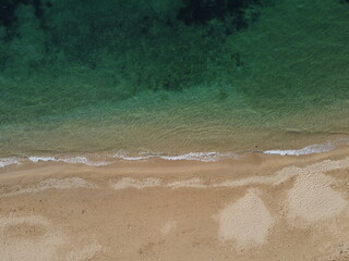 Beautiful remote beach with crystal clear azure water, aerial view. Untouched nature and hidden...