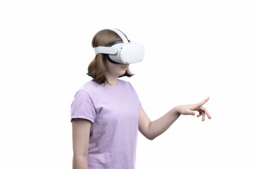Girl in purple shirt with virtual reality headset glasses isolated on white background. VR device and finger touch in air. Concept of cutting edge technology, video games, innovation.
