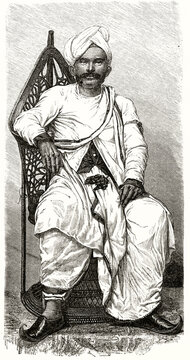 Indian doctor white dressed with turban posing seated on a woven chair in Reunion island. Ancient grey tone etching style art by Mettais, Le Tour du Monde, 1862